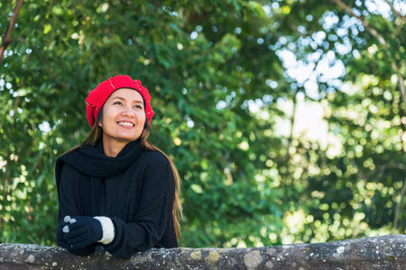 Portrait Asian Woman relaxing in green park. Happy Relax asian woman smiling face at outdoors garden. Young women enjoy nature freedom lifestyle. Greenery wellbeing outside beauty in nature.の写真素材