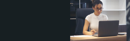 Banner Businesswoman hands type on laptop writing on notebook meeting at office desk. Banner Asian Woman Hands write planning office laptop. Female hand holding pen plan business with copy spaceの写真素材