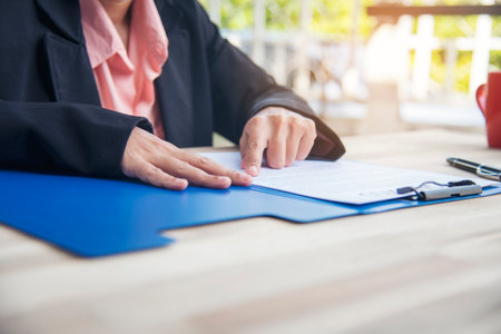 Close up businesswoman hands manager signing reading business contract document. Businesspeople hand...