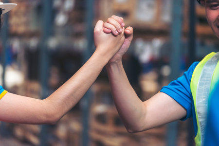 Diversity Teamwork Warehouse worker fist bump together trust partner. Engineer man, women hands partnership. Coworker colleague logistics Warehouse agreement. Multiracial Two people fist bump partnerの写真素材
