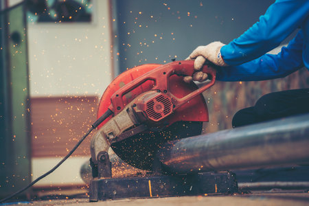 Construction Worker hands using Welding machinery iron metal sparking. Men hands wear protective...