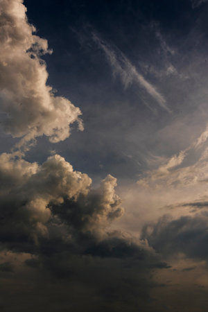 Vertical Dramatic dark storm rain clouds black sky background. Dark thunderstorm clouds rainny...