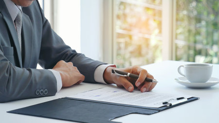 Businessman hand using pen signing on new contract starting projects in conference room. Close up...
