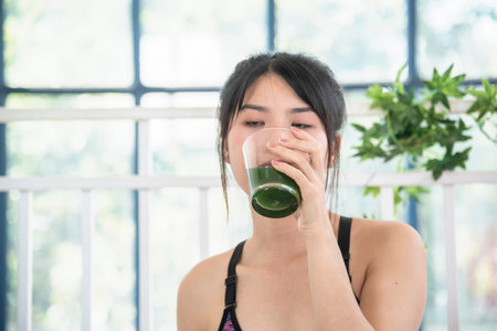 Women hands holding smoothie detox green juice fresh fruit cool drinking. Asian women smile laugh...