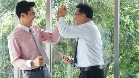 Success Businessman happy got good news mobile smartphone. Excited two businessman ceo company...