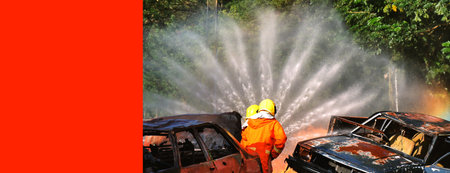 Firefighter Rescue training in fire fighting extinguisher. Firefighter fighting with flame using...