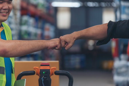 Diversity Teamwork Warehouse worker fist bump together trust partner. Engineer man, women hands partnership. Coworker colleague logistics Warehouse agreement. Multiracial Two people fist bump partnerの写真素材