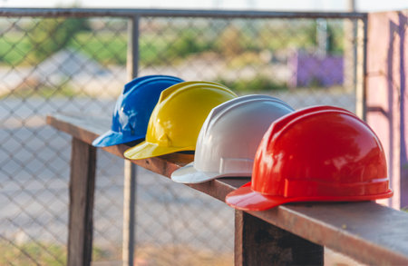 Construction hard hat safety tools equipment workers in construction site engineering protection head hang on wood wall. Many hard hat row helmet with copy space. Engineering Construction Conceptの写真素材