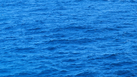 Turquoise ocean sea water white wave pattern splashing deep blue sea. Seascape dark ocean background...