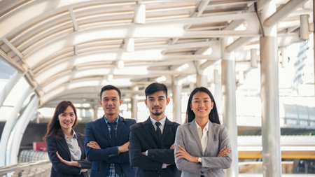 Portrait Group of businesspeople arms crossed smiling look at camera in modern city background....