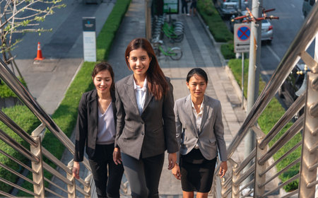 Team leadership businesswoman walking together on street city life. Group of business people team...