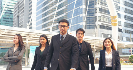 Portrait Group of businesspeople arms crossed smiling look at camera in modern city background....