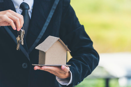 Real estate agent hands holding home business mortgage loan investment property. Hands saving protection home residential concepts. Insurance Agent sale residence ownership household protection careの写真素材