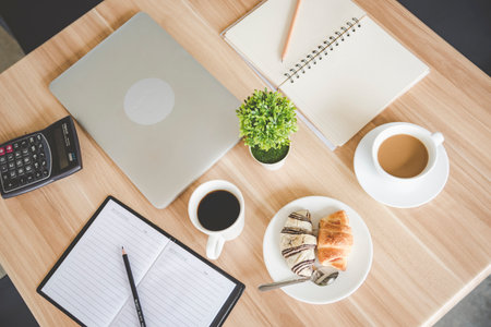Banner Office laptop business financial document chart and graph on office wooden table coffee cup. Panorama Flat lay notebook computer laptop on office desk. Business stuff mockup with copy spaceの写真素材
