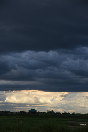 Vertical Dramatic dark storm rain clouds black sky background. Dark thunderstorm clouds rainny...