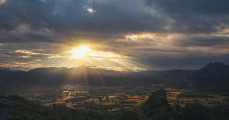 Scenic view dramatic beautiful sunset sky. Natural Sunset Sunrise on meadow silhouette shadow dark land. Vibrant dramatic sky on sunset, dawn, sunrise in Countryside. Landscape Colorful Sky At Sunsetの写真素材