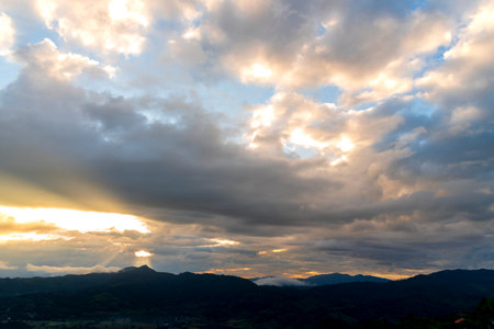 Scenic view dramatic beautiful sunset sky. Natural Sunset Sunrise on meadow silhouette shadow dark land. Vibrant dramatic sky on sunset, dawn, sunrise in Countryside. Landscape Colorful Sky At Sunsetの写真素材