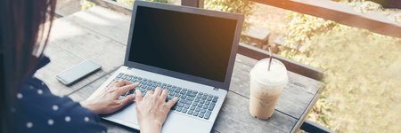 Banner Woman typing laptop computer online meeting at home office work from home. Asian businesswoman use notebook laptop. Programmer woman typing keyboard laptop read online website with copy spaceの写真素材