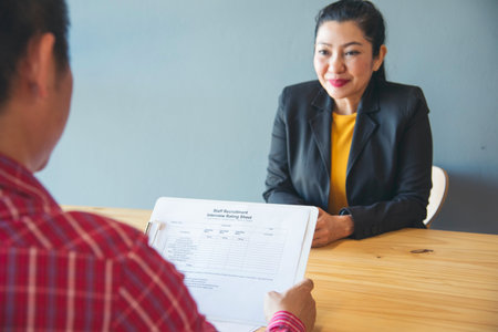 Job HR applicants having an interview with Human resource manager jobs interviewing with confident candidate at business firm office give cv resume. Job Interview with headhunter agent and applicantの写真素材