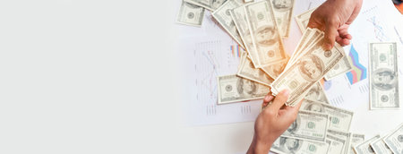 Banner Backside Businessman spreading 100 dollar banknote back jeans pocket. Hand holding money dollar bank note. Banner Man hands spread 100 dollar exchange cash with copy space.の写真素材