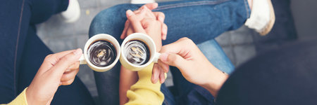 Banner Asian Business people smiling Relax holding cup of coffee in modern city. Couple lover enjoy drinking takeaway hot coffee together. Young Business people holding cup of coffee with copy spaceの写真素材