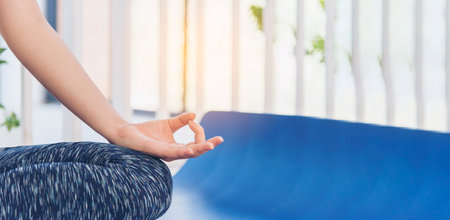 Banner Yoga fitness lifestyle healthy woman relaxation doing meditation. Yoga meditate outdoor zen sitting position. Banner Yoga woman workout sportswear sit on yoga mat home fitness with copy spaceの写真素材