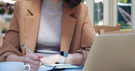 Woman working business office desk using laptop work from home. Businesswoman looking financial business chart, graph, infographic analyze sale statistics. Woman hands on entrepreneur office deskの写真素材