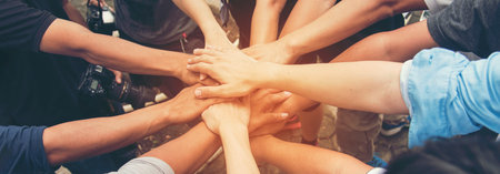 Banner diversity solidarity team multiethnic Partners hands together teamwork. Group of multiracial...