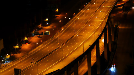Blurred background night city bokeh car drive on road in nightlife. Light line traffic jam in black...