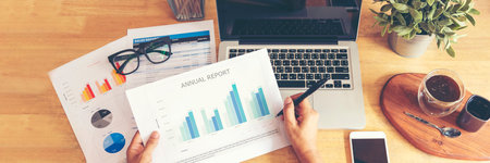 Banner Businesswoman reading financial graph charts business info with computer laptop. Panorama...