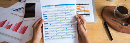 Banner Businesswoman reading financial graph charts business info with computer laptop. Panorama...