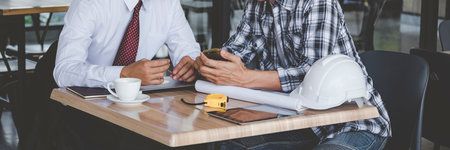 Banner Contractor construction engineer meeting on architect table at construction site. Businessman...