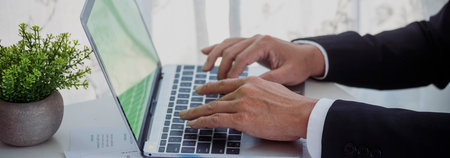 Banner Asian Business man hands using calculator counting tax financial bill. Tax audit Financial concept. Panorama Close up businessman hands calculating number tax audit planning with copy spaceの写真素材