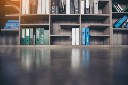 Blurry Library background off white Backdrop bright softness bookshelf with copy space. Book case Blurred background bright library silver gray lighting.の写真素材