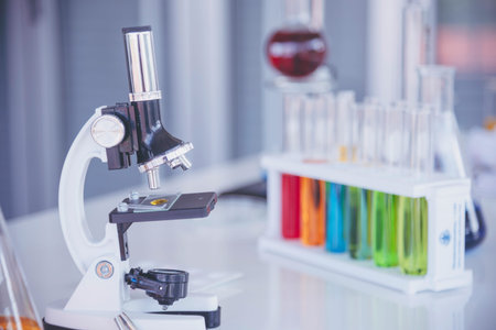 Science laboratory chemistry test science lab with microscope, glass tubes, chemical beaker white table scientific background. Colorful Liquid biology laboratory chemical fluid scientist experimentの写真素材