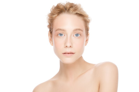Skin care treatment or cosmetic ads concept. Beauty woman face with blue eyes and blond hair looking at camera, isolated on white background. Beautiful model girl with perfect clean fresh skinの写真素材