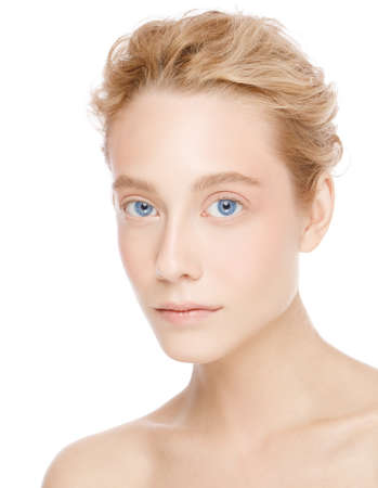 Vertical portrait of young beautiful blonde woman with blue eyes, concept of perfect skin care and beauty, isolated on white backgroundの写真素材