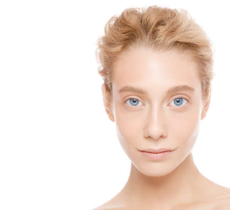 Vertical portrait of young beautiful blonde woman with blue eyes, concept of perfect skin care and beautyの写真素材