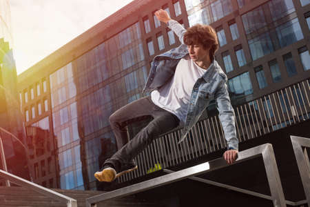 Young athletic guy doing tricks and parkour in the cityの写真素材