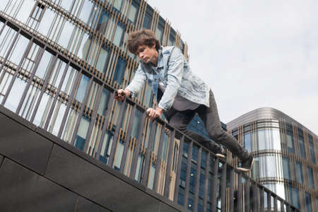 Young athlete risks own life doing parkour in the cityの写真素材