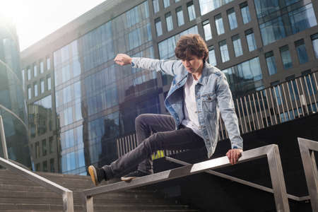 Young active man doing extreme parkour and stunts in the cityの写真素材