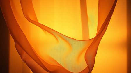 Closeup of yellow drapery on orange background. Studio shot.の素材