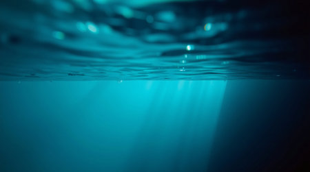 Underwater view of the sea surface. Deep blue water background.の素材