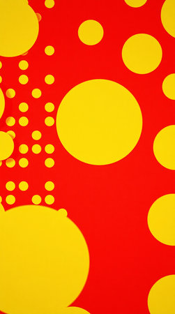 Yellow polka dot pattern on red background, closeup of photoの素材