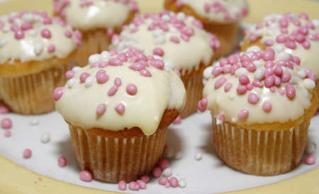 Muffins with white chocolate and pink and white miceの写真素材