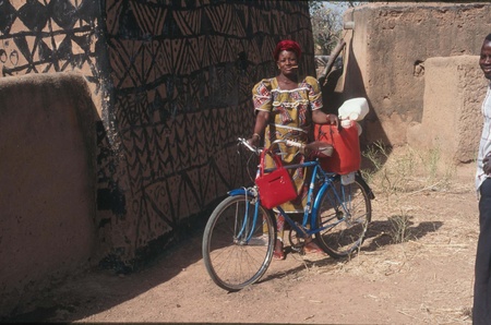 West African Woman with bicycleの写真素材