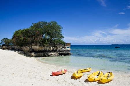 Kayaks in sunny tropical beachの写真素材