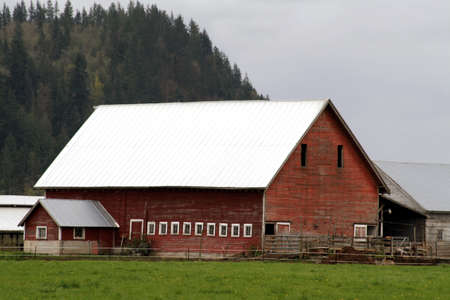 Red barn on a cloudy day in the countryside..