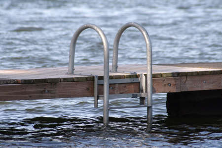 Ladder at a lake swimming down going down into the water.の写真素材