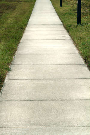 Sidewalk with grass on each side.の写真素材